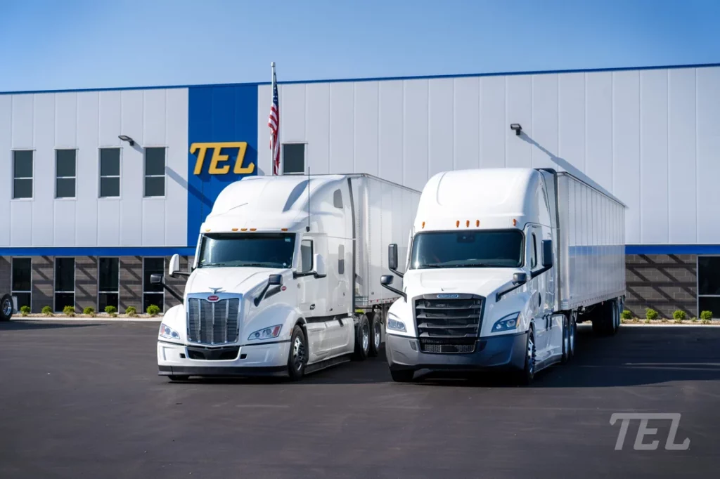 Two TEL tractor trailors side by side.